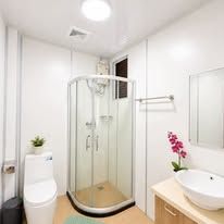 Clean bathroom with glass shower enclosure and modern vanity