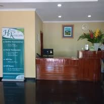 A polished timber reception desk at the hotel lobby entrance.