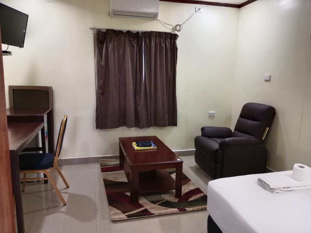 Guest suite living area with leather recliner and coffee table.