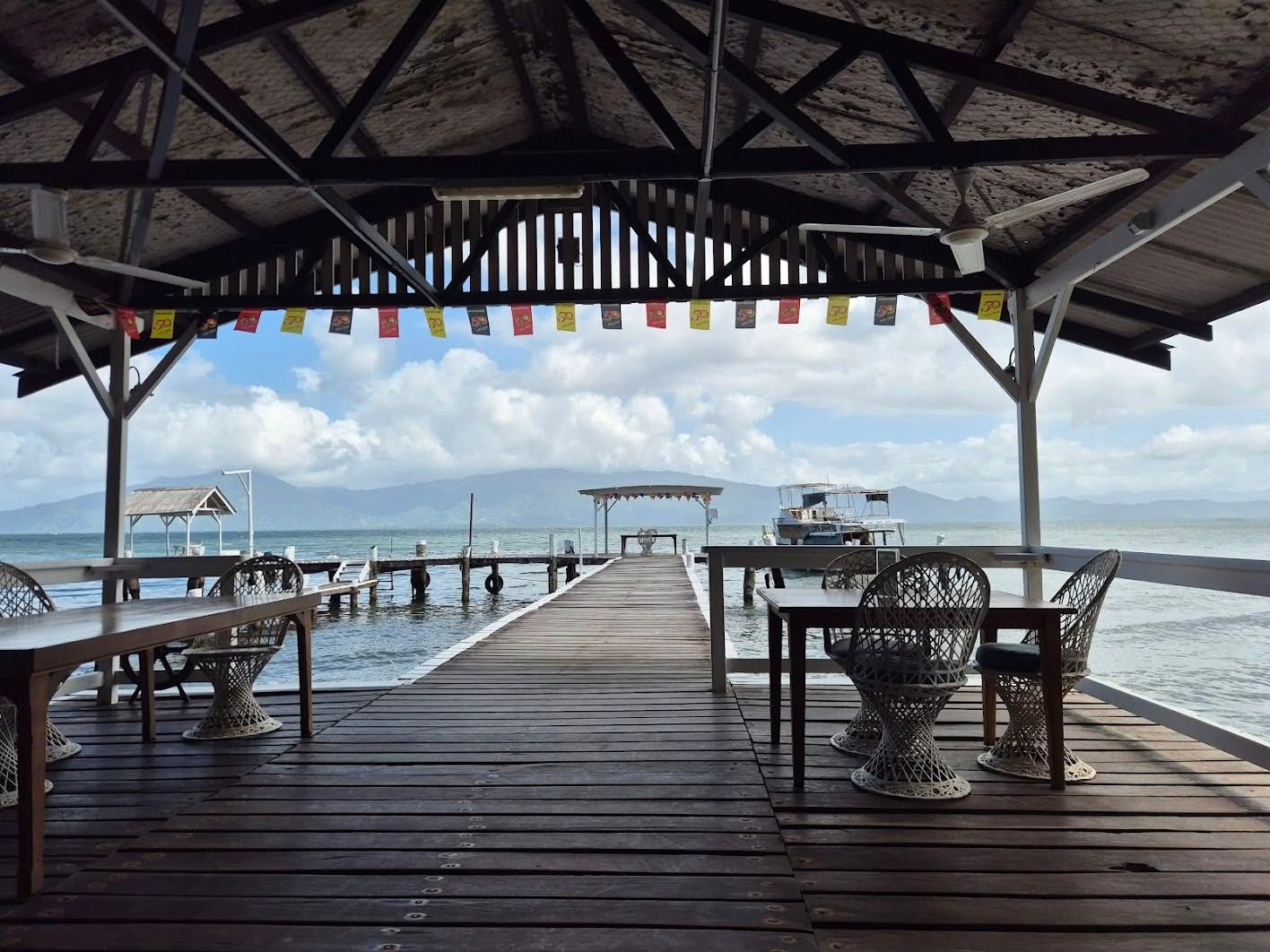 View of the ocean and private jetty from the shaded wooden deck