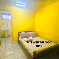 Guest room with yellow walls and an attached bathroom area.