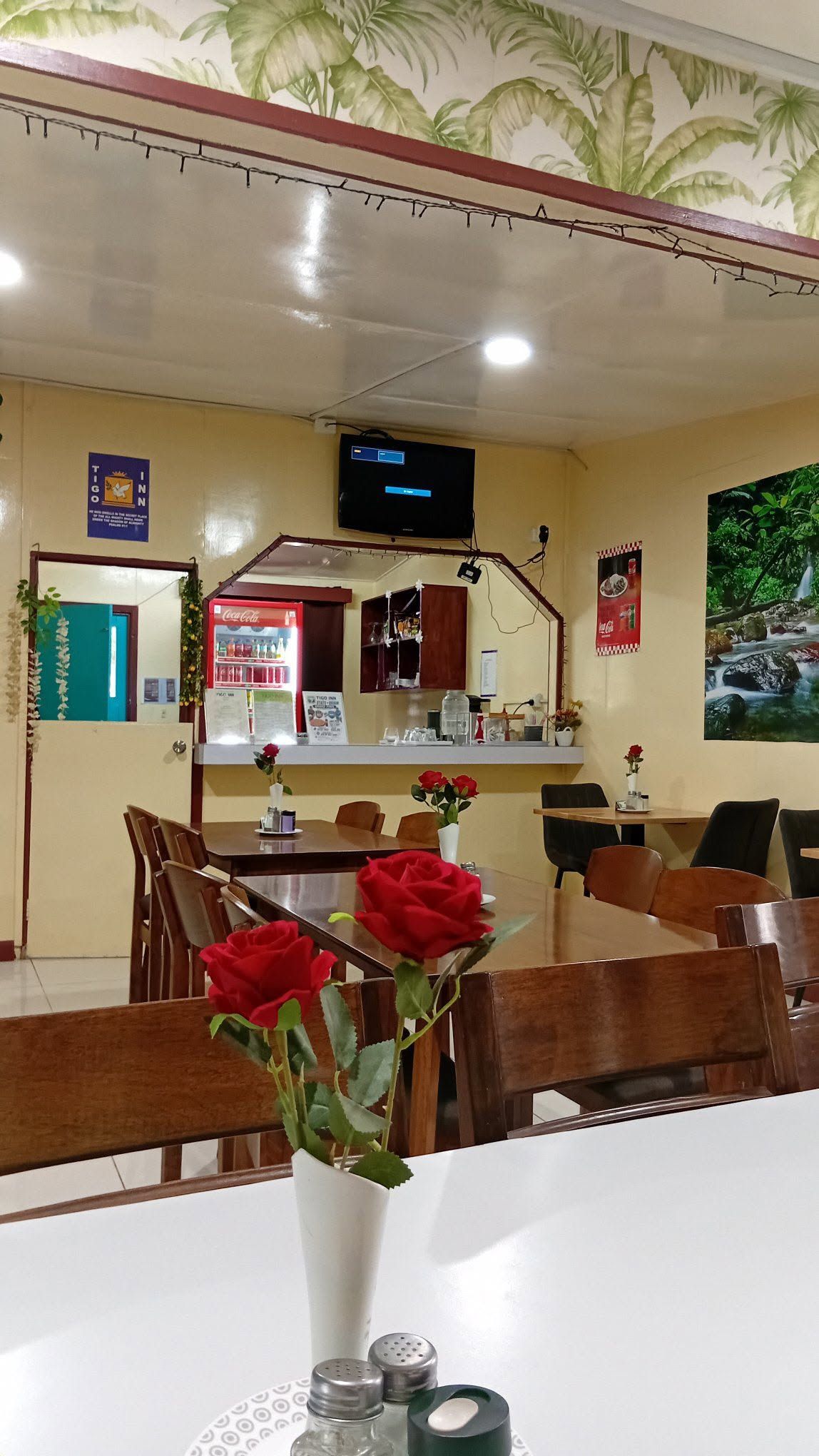 Indoor dining room featuring wooden tables and a small beverage counter.