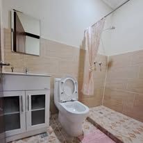 Clean bathroom with walk-in shower, toilet, and vanity sink.