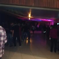 Indoor event space with low lighting and purple accents