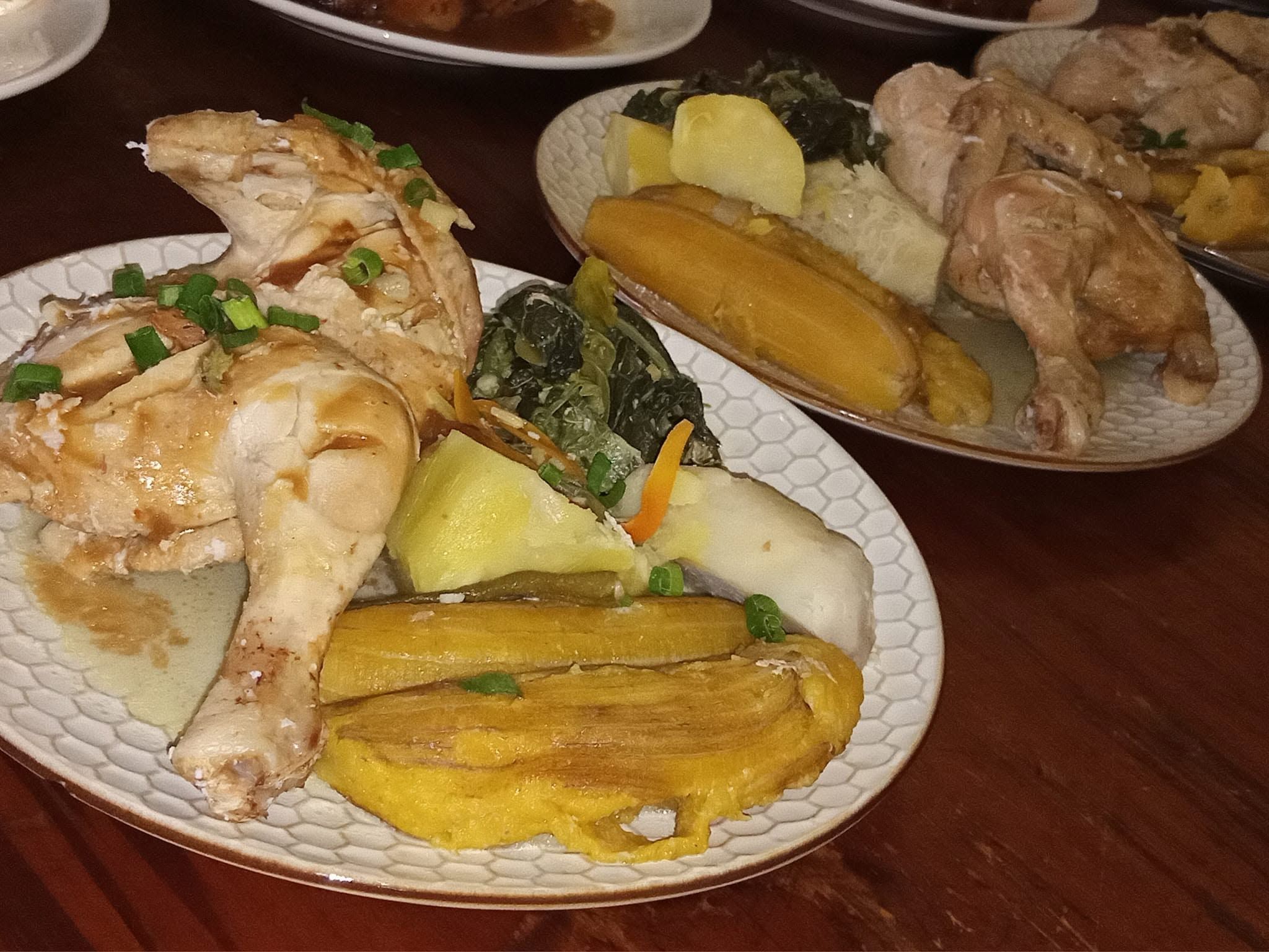 Roasted chicken portions served with boiled local root vegetables.