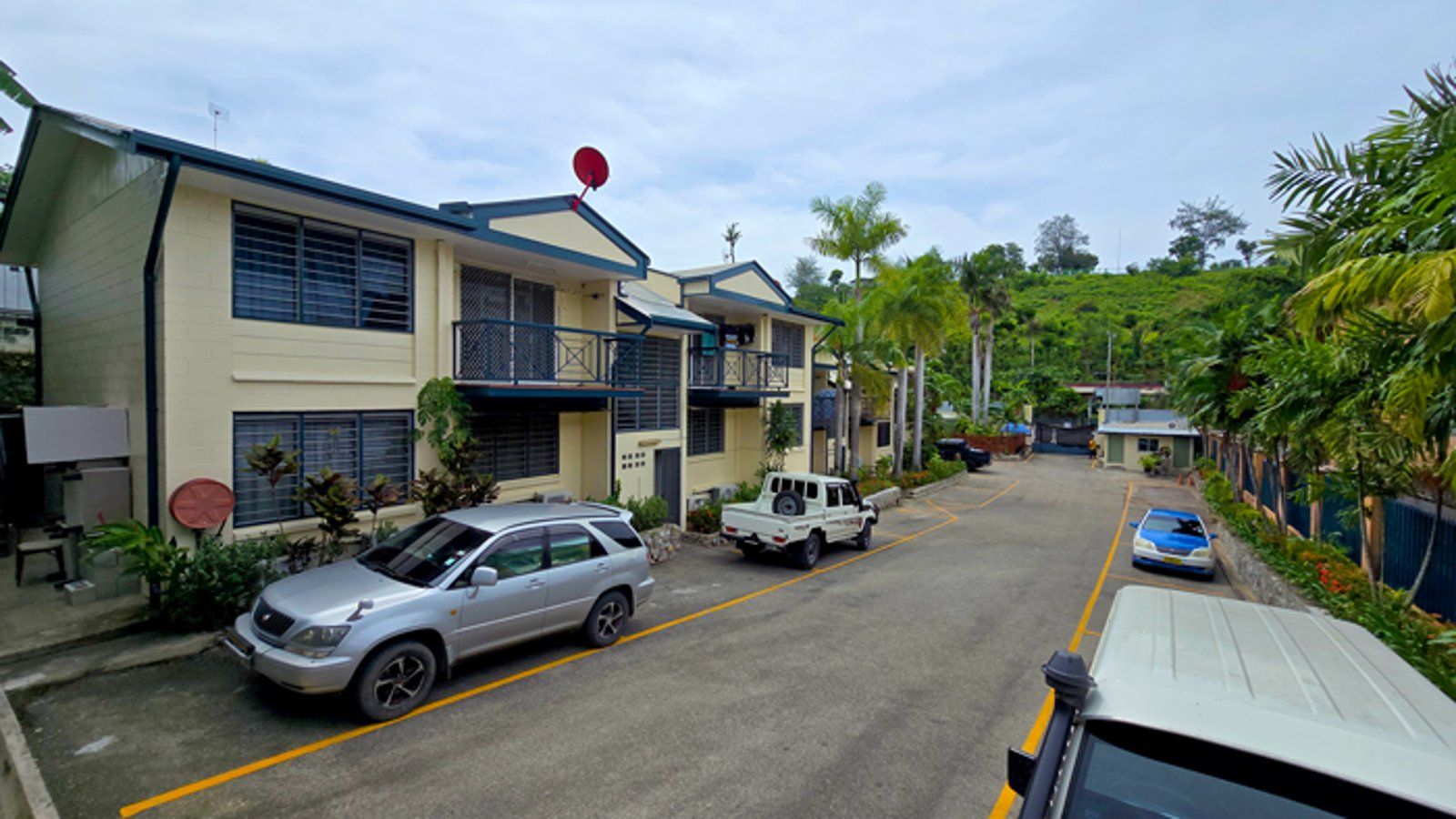 Exterior view of the multi-story motel buildings and guest parking area.