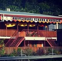 Two-story lodge building with red stairs and Rising Sun Lodge signage.