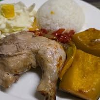 Plated meal including roast chicken leg, steamed rice, and vegetables.