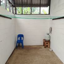 Utility space featuring a laundry line and a gas cylinder setup.
