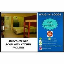 Self contained guest room with wooden bunk beds and en-suite facilities.
