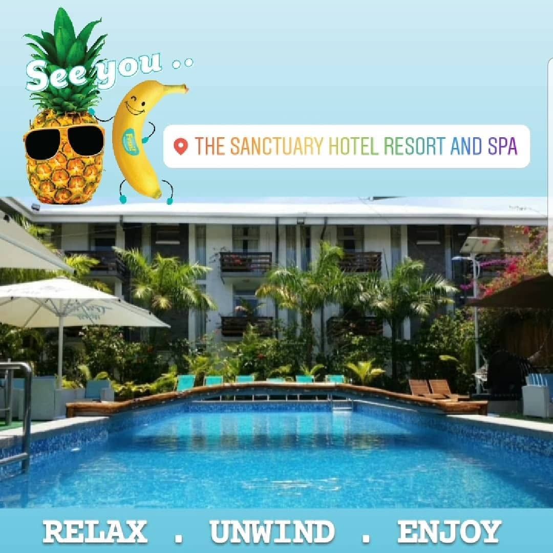Swimming pool with resort building in the background.