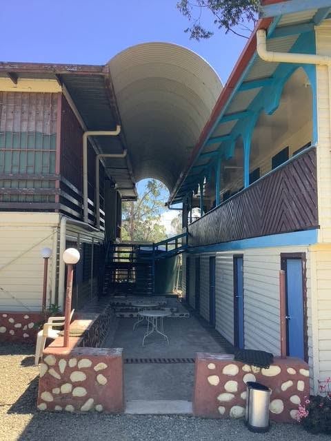 A sheltered walkway and common area between two accommodation wings.