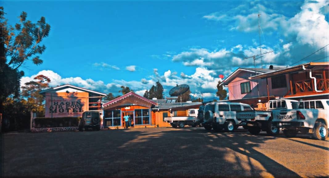 Wide exterior view of the motel buildings and parking area.