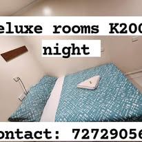 Double bed with patterned blue bedding in a guest room
