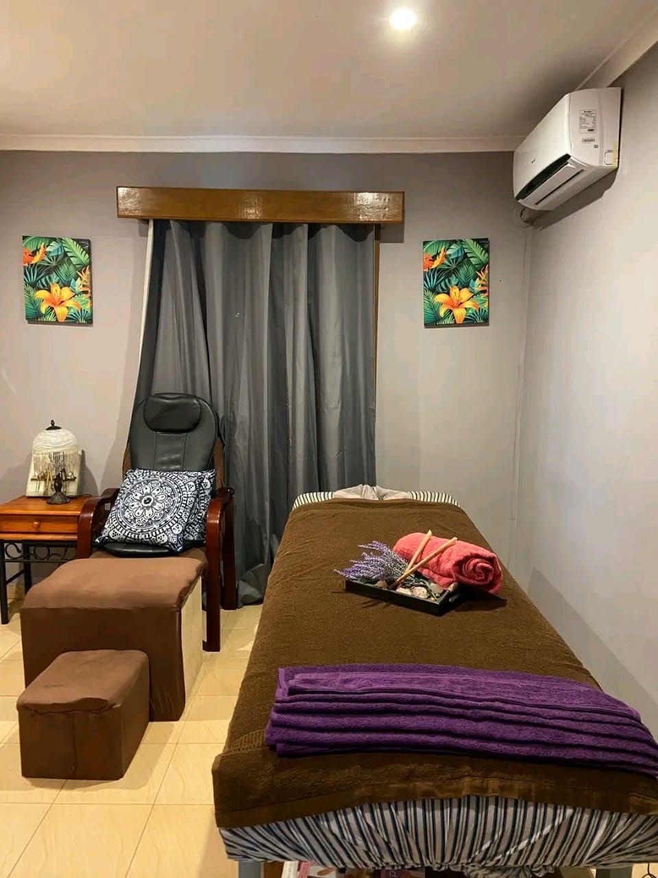 On-site spa treatment room with a massage bed and professional seating.