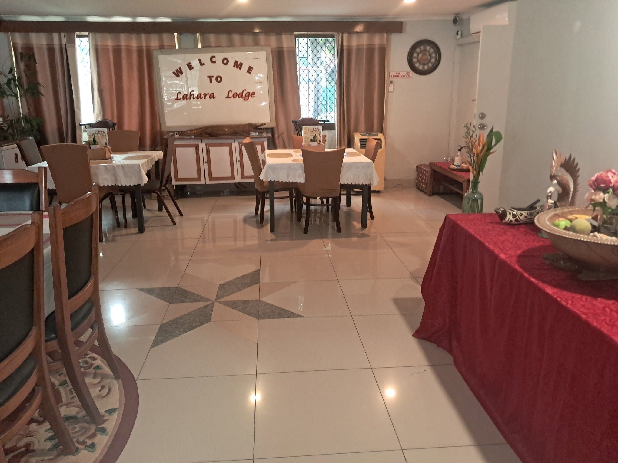 Lodge dining room with organized table settings and welcome signage.