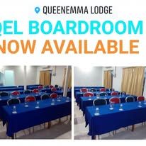 Conference room setup with blue table cloths and red chairs.