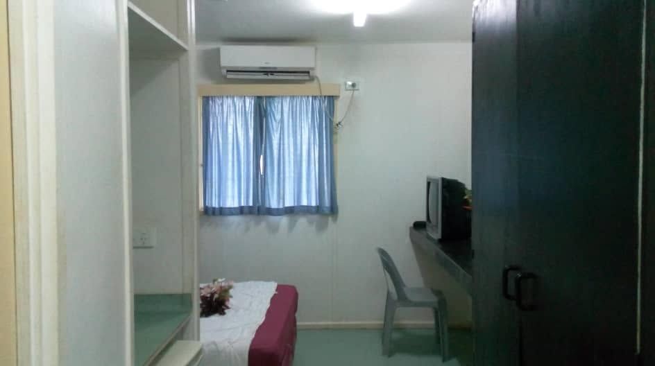 Guest room interior featuring air conditioning unit and desk area.