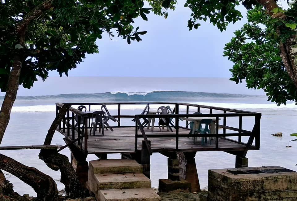 Raised wooden viewing deck overlooking the ocean surf and reef.