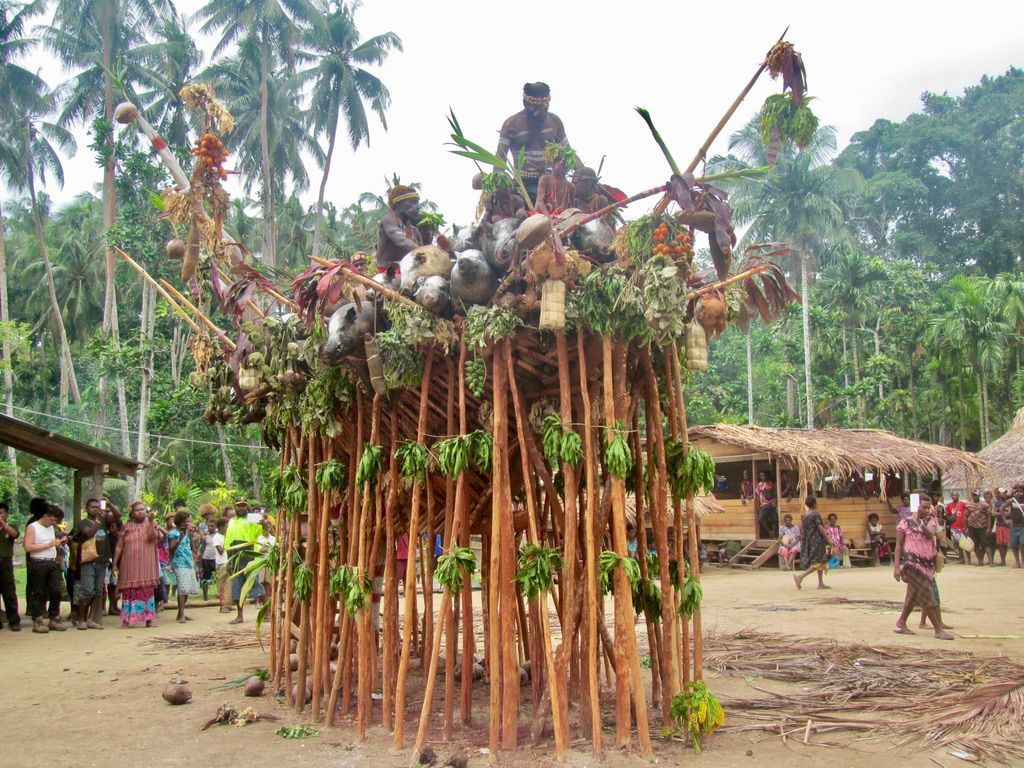 Cultural event featuring traditional structures and local residents.