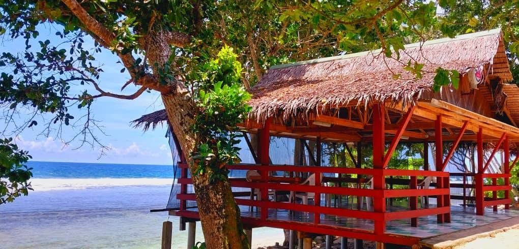 Beachfront wooden pavilion used for dining and relaxation
