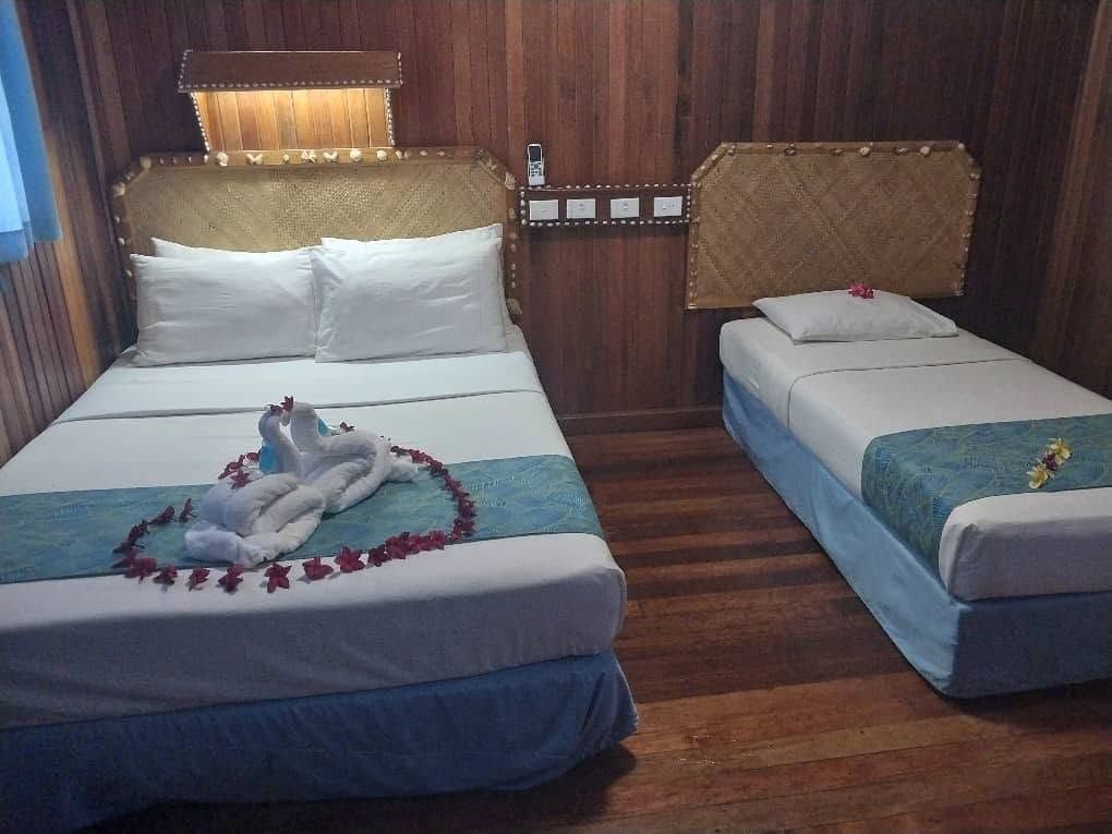 Double and single bed arrangement with swan towel art