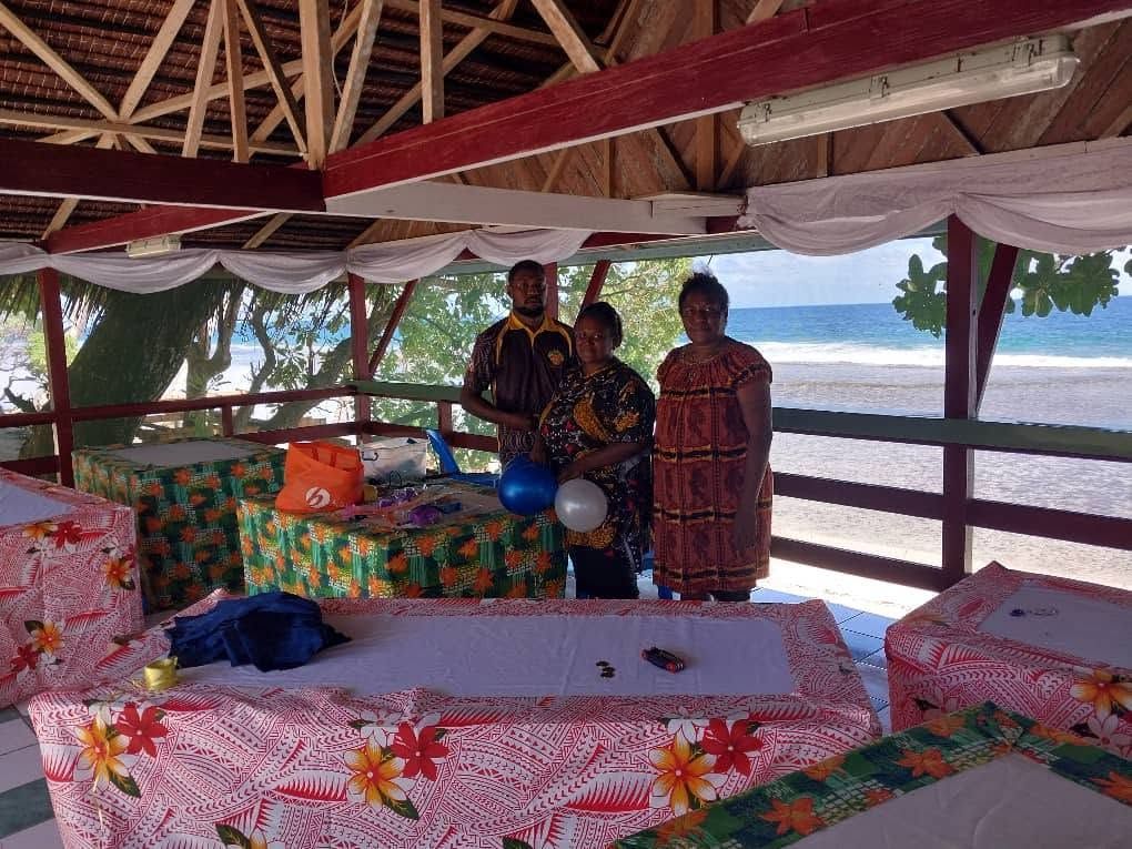 Resort staff preparing an event space with colorful table linens