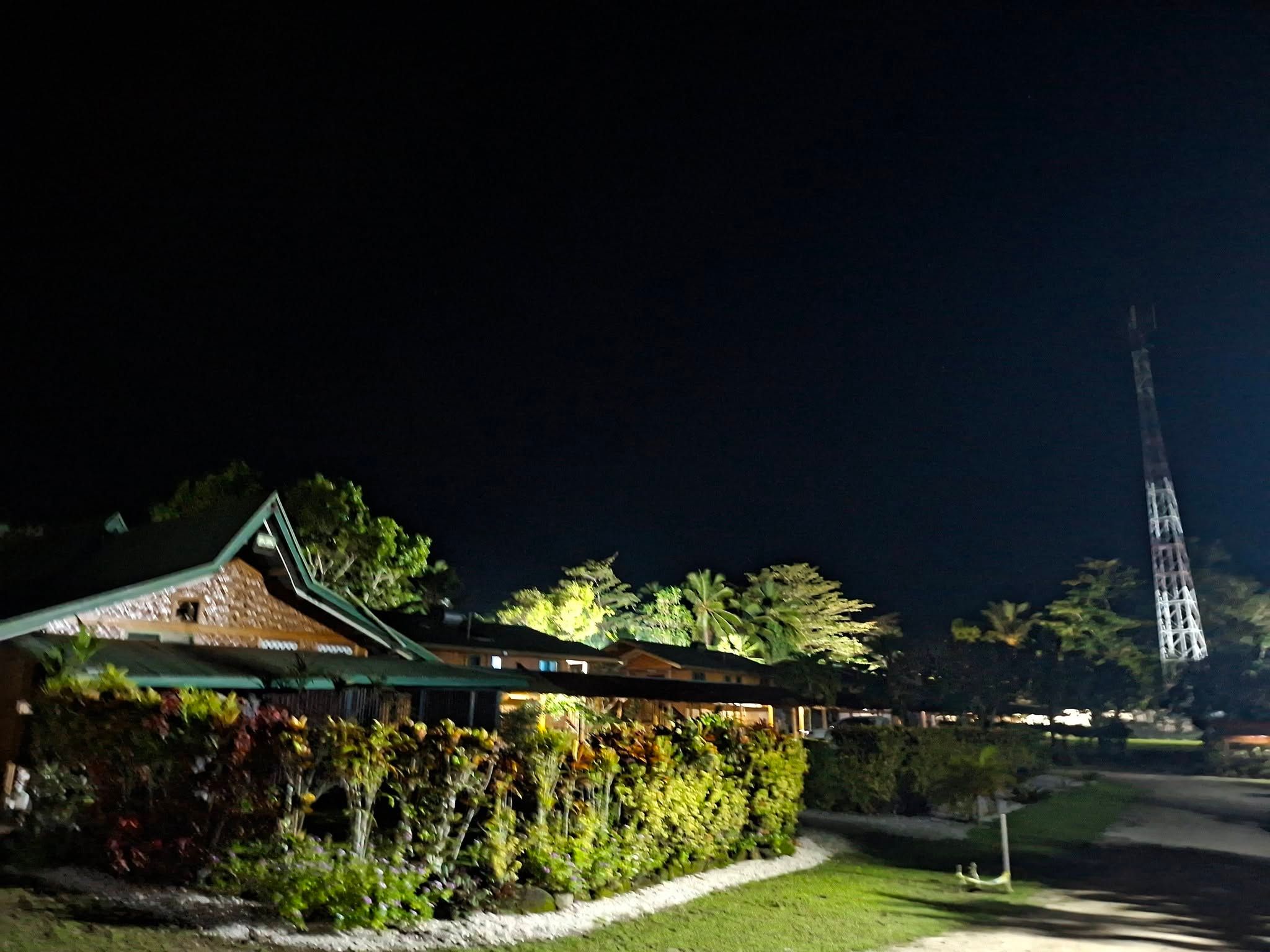 Exterior view of the resort buildings lit up at night