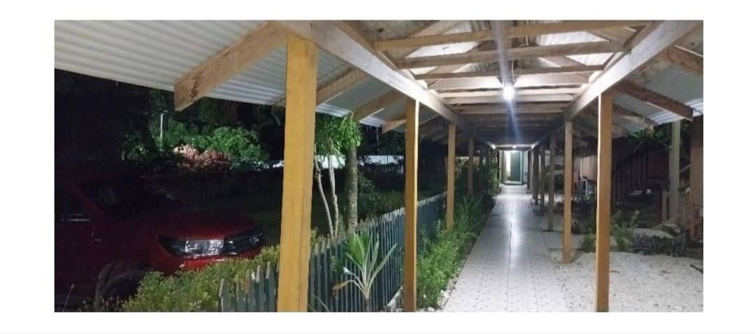 Covered wooden walkway connecting resort units at night