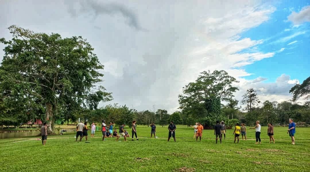 Group of guests participating in team activities on the central lawn.