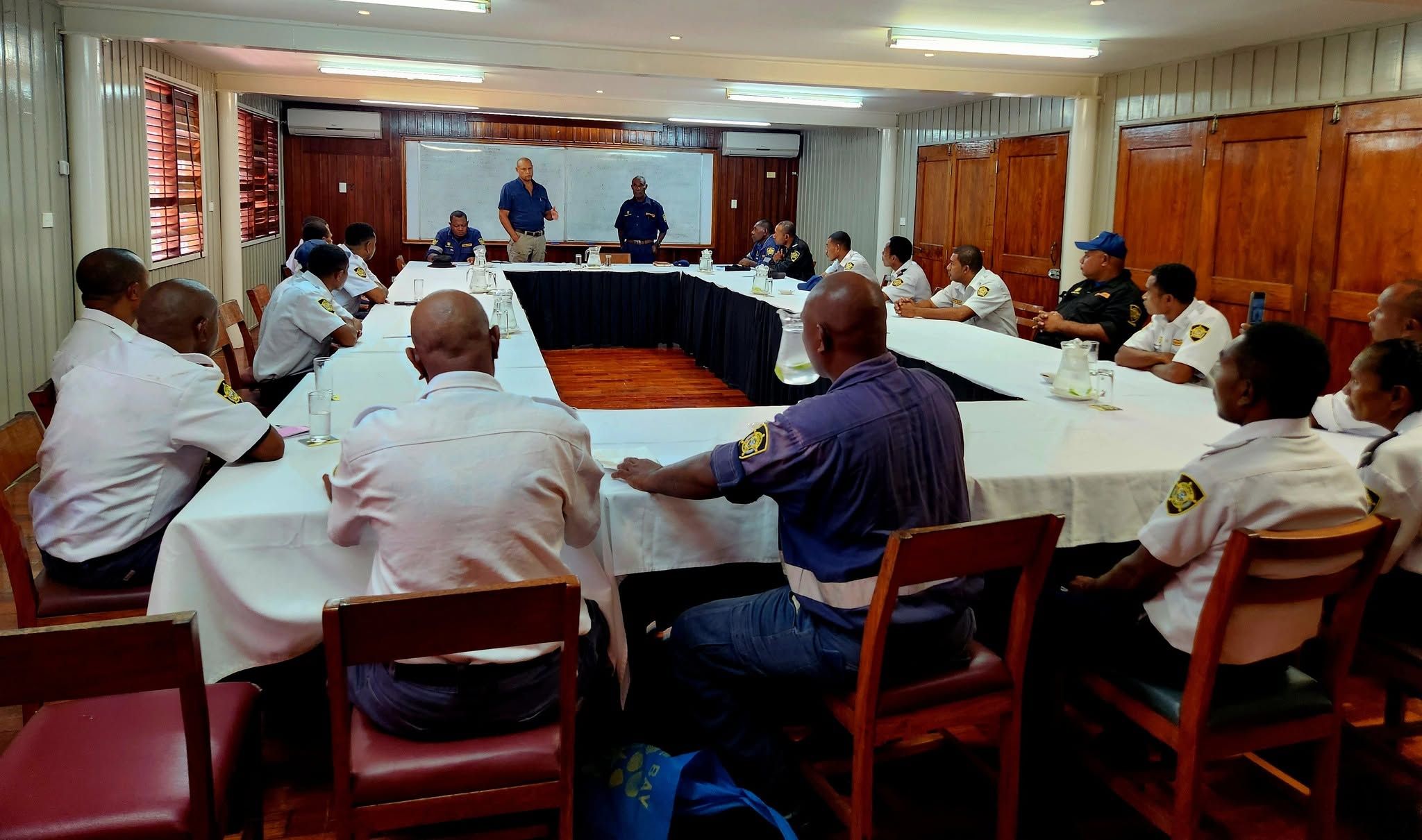 The conference room arranged with tables for a professional meeting.