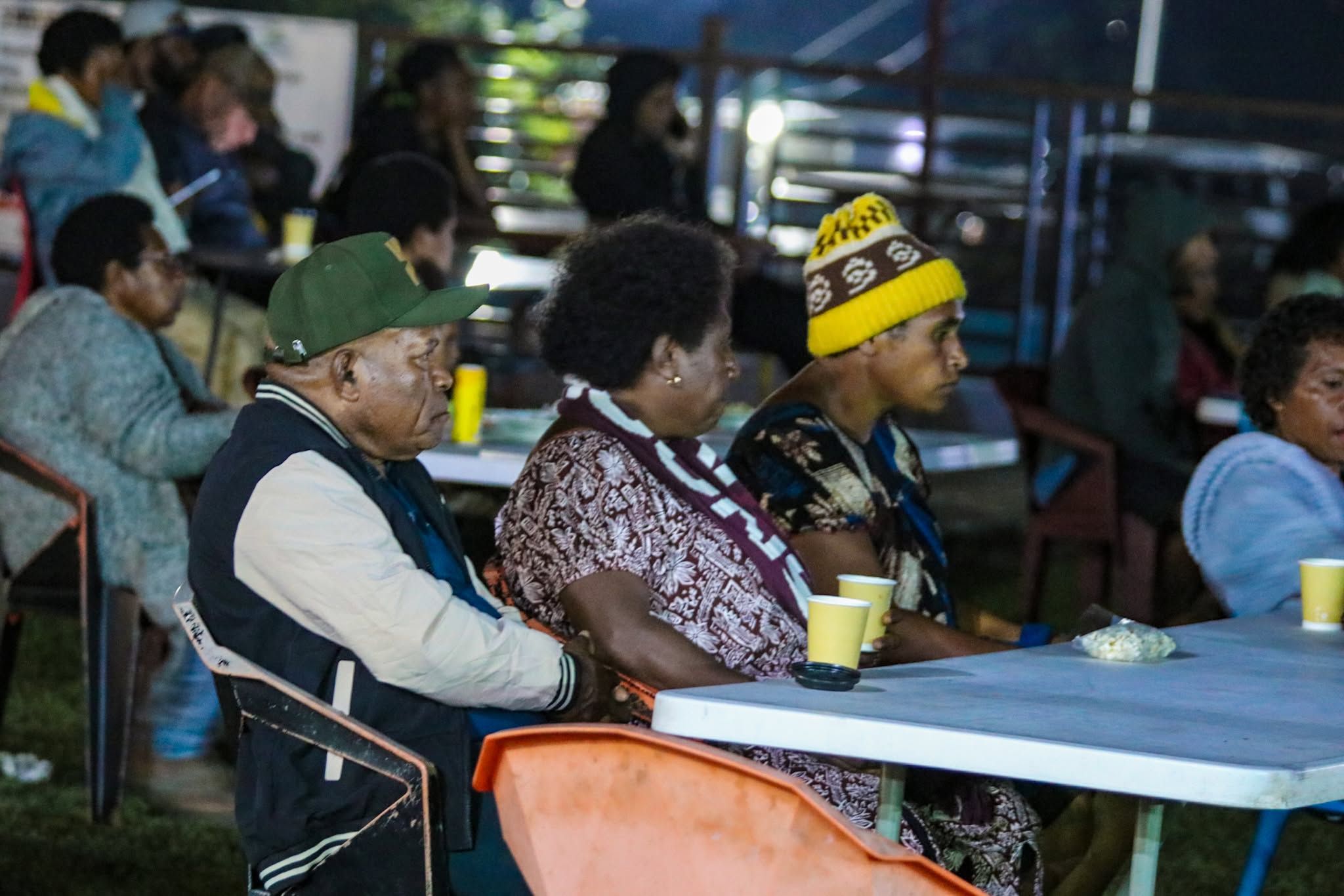 Guests enjoying an evening event at outdoor tables