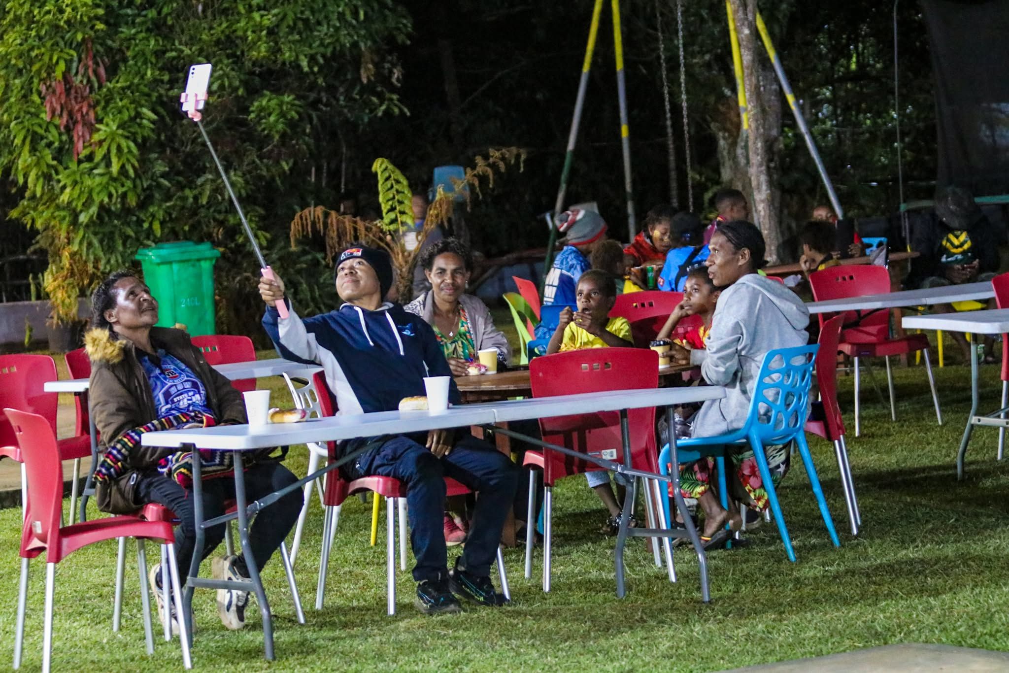 Guests socialising and taking a selfie at a night function