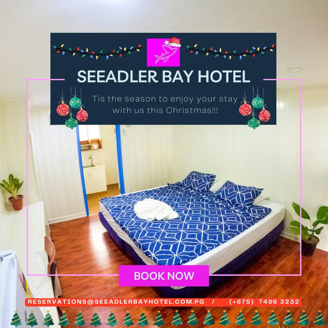 Clean guest room featuring a large bed with blue patterned linens