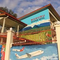 Colorful mural and signage at the hotel entrance gate.