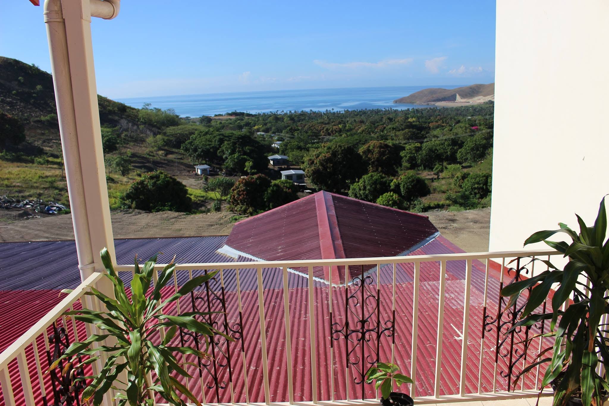 Panoramic ocean and coastline view from a high Vantage point balcony.