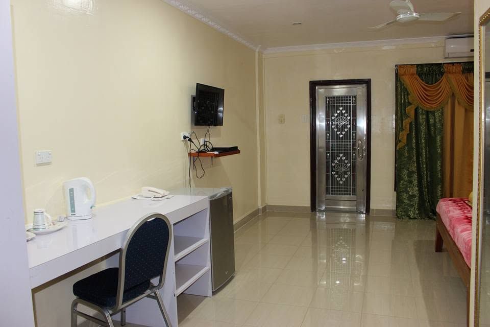 Modern guest room interior including a desk area and mini-fridge.