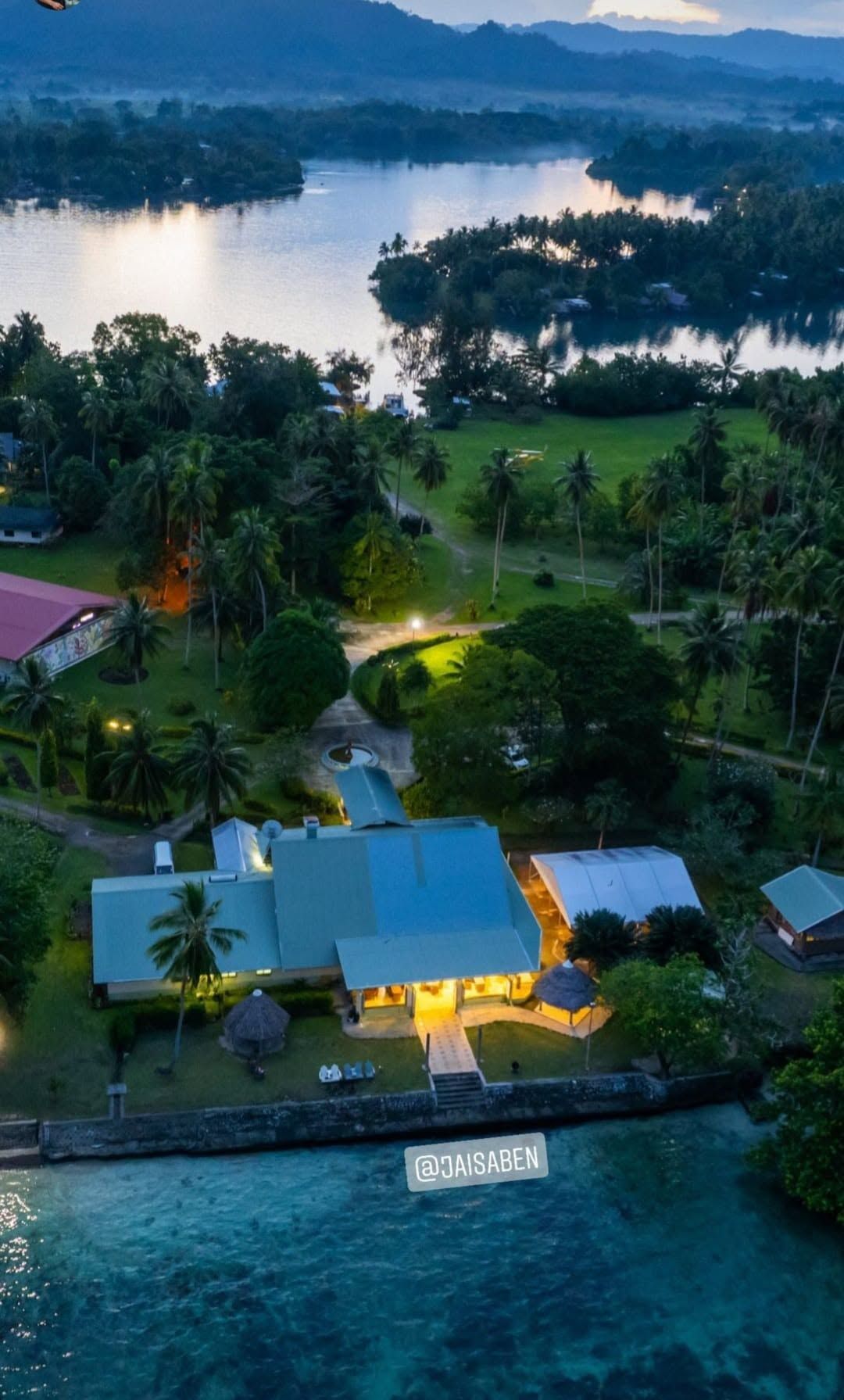 High-altitude aerial view of the resort's lush grounds and bay.