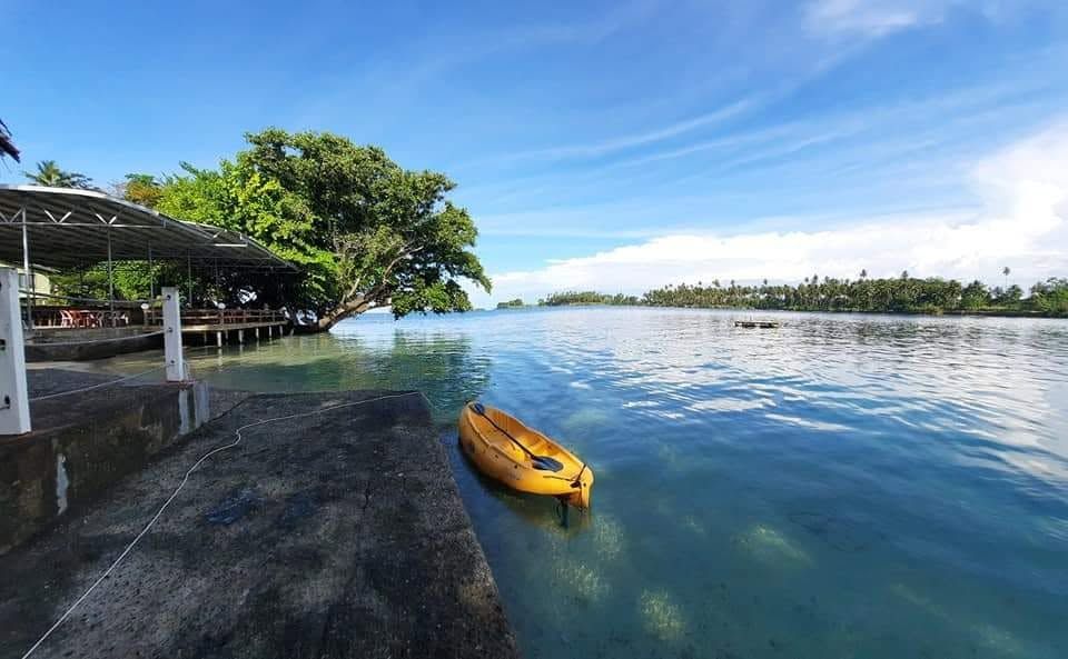 A yellow kayak resting by the resort's concrete jetty.