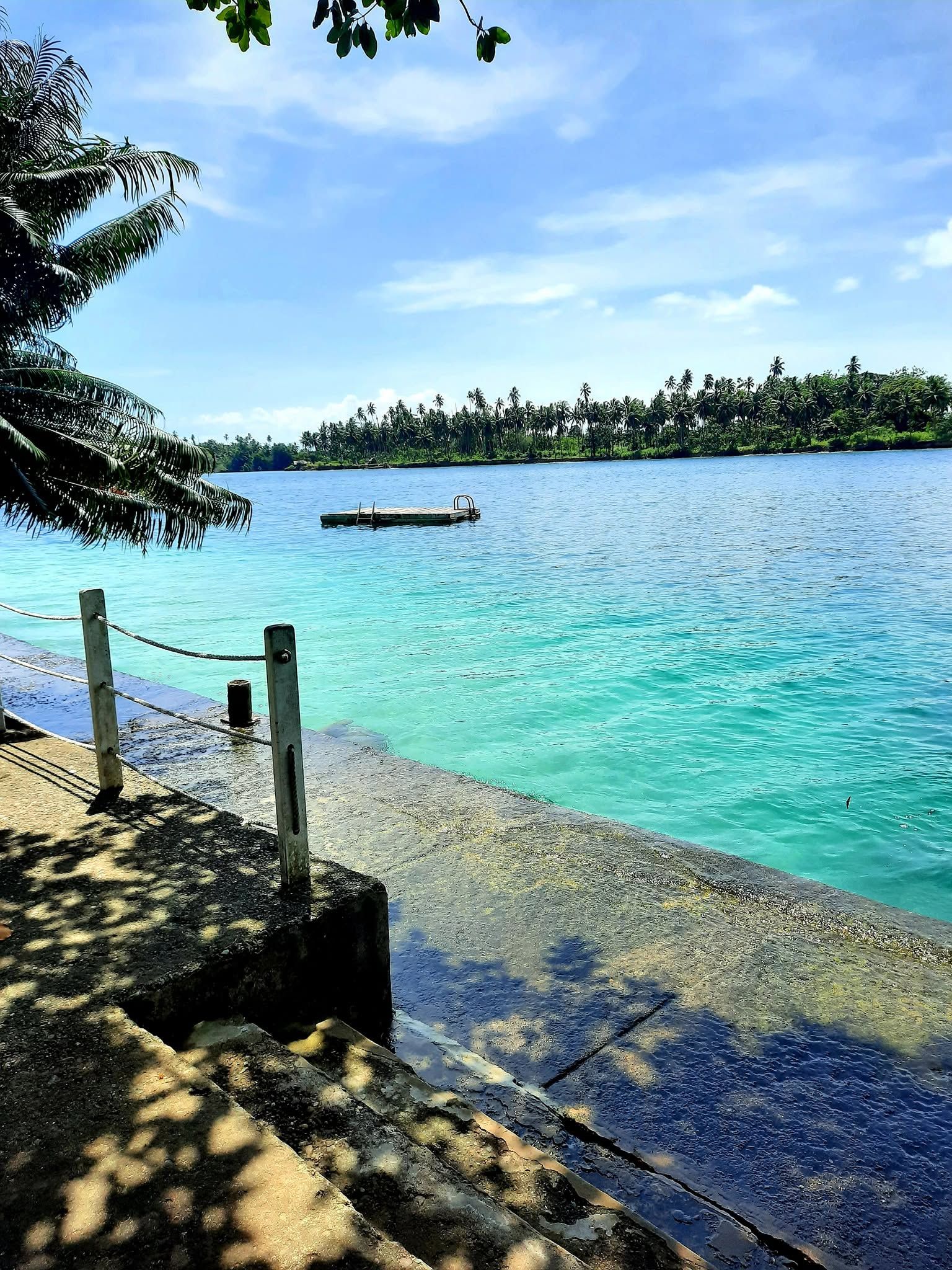 The concrete boat ramp area overlooking the turquoise lagoon.