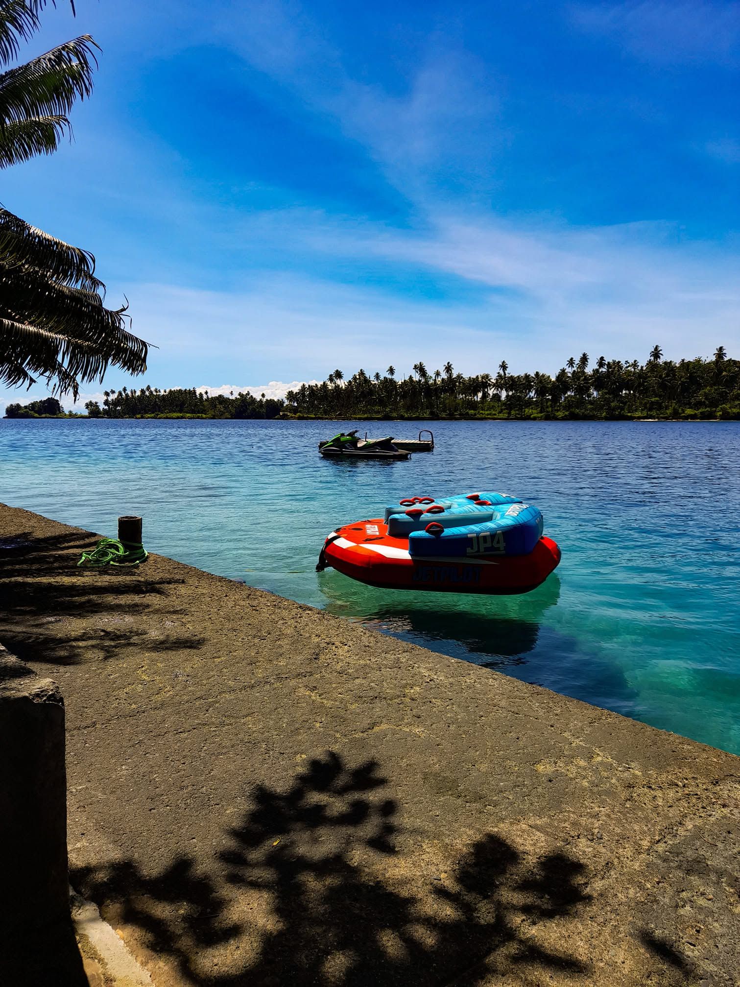 Inflatable water sports tubes floating near the resort jetty.