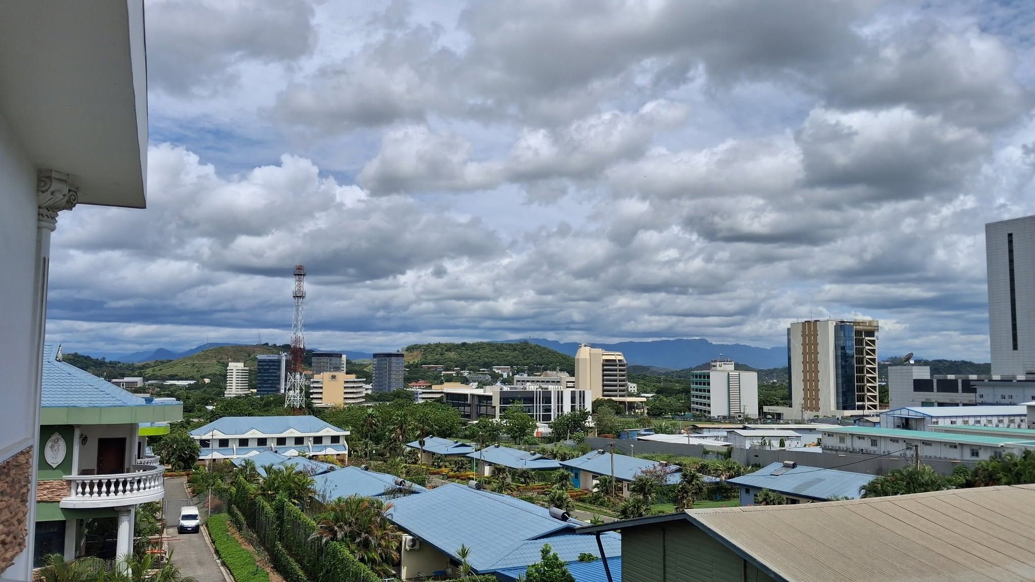 Elevated city view of Waigani featuring commercial buildings and greenery.