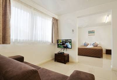 Spacious apartment layout showing a lounge area and separate bedroom.