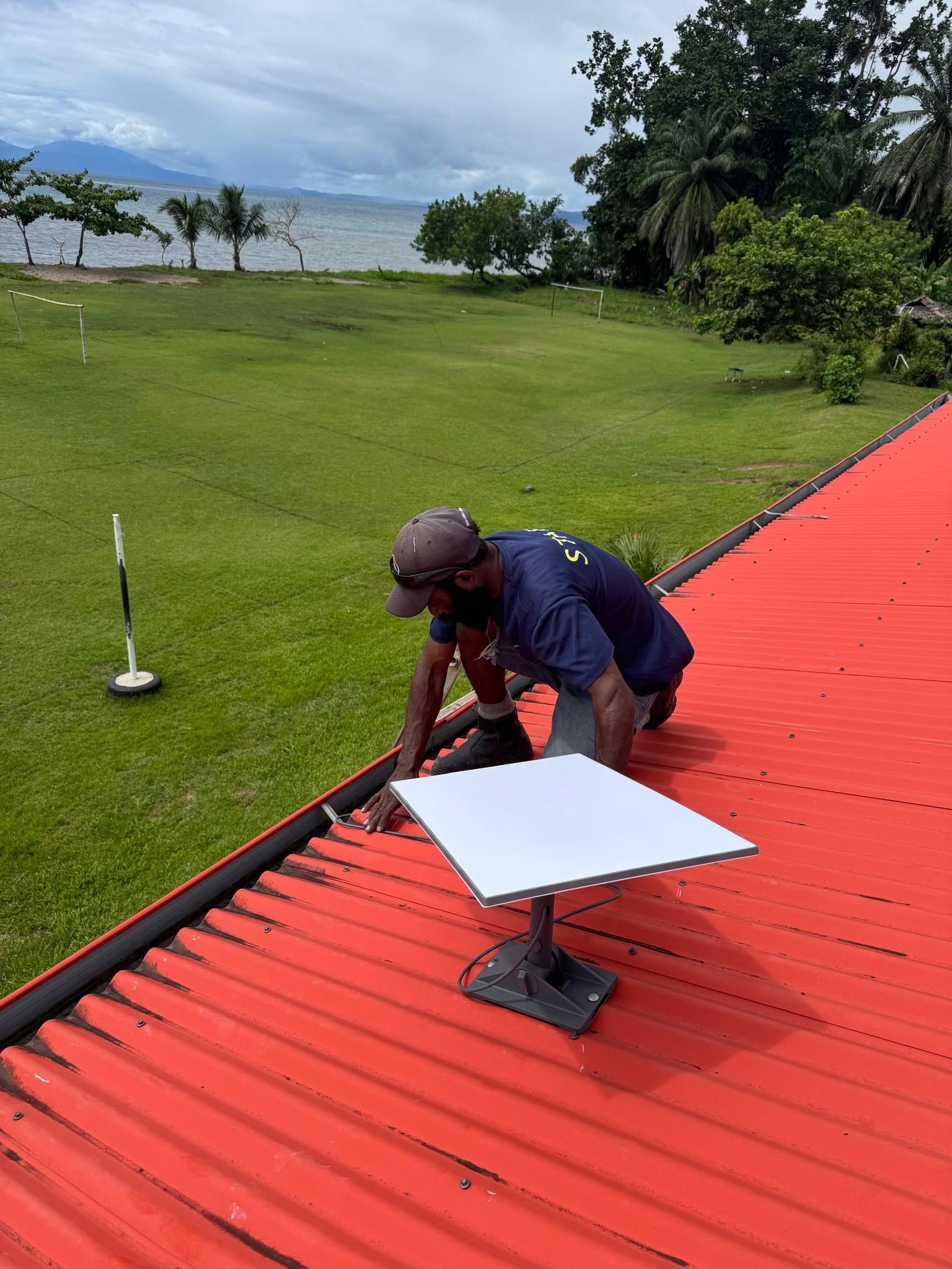 Installation of high-speed satellite internet hardware on the resort roof.