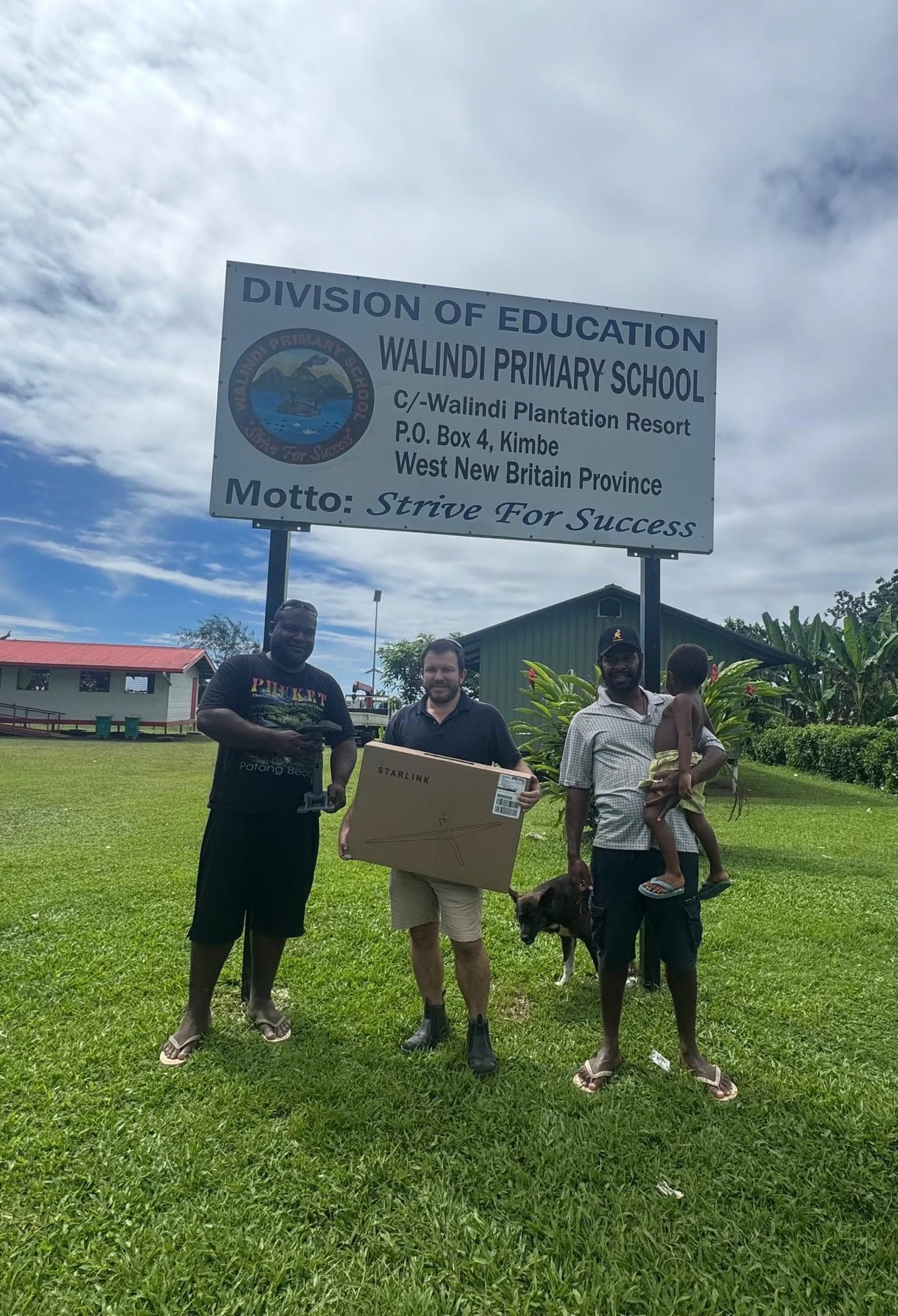 The Walindi Primary School entrance sign surrounded by green grounds.