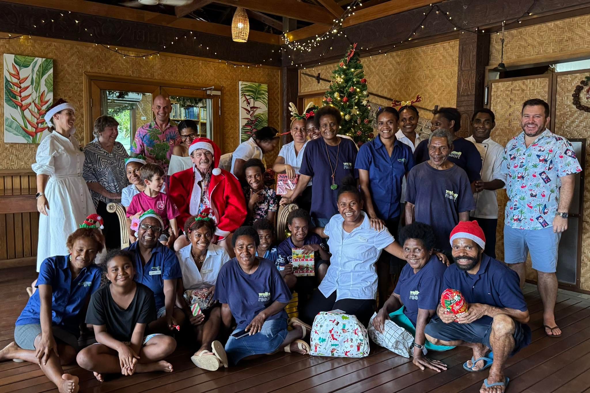 Staff and guests celebrating Christmas in the resort common area.