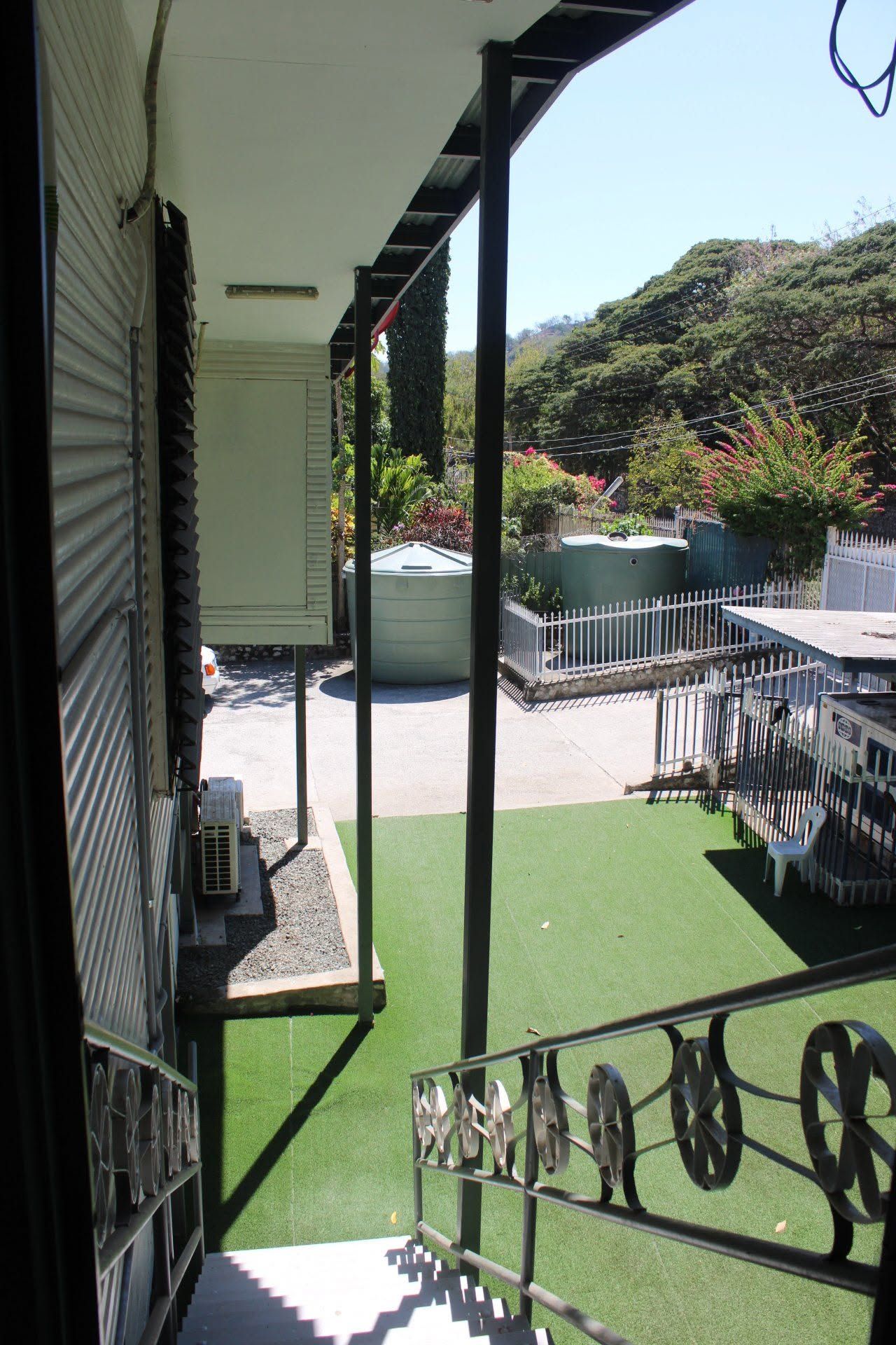 View from the upper level overlooking the synthetic grass courtyard and water tanks