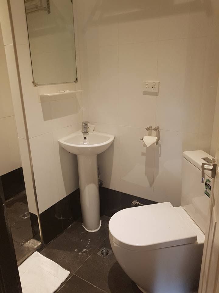 Bathroom featuring a white pedestal sink and a standard toilet.