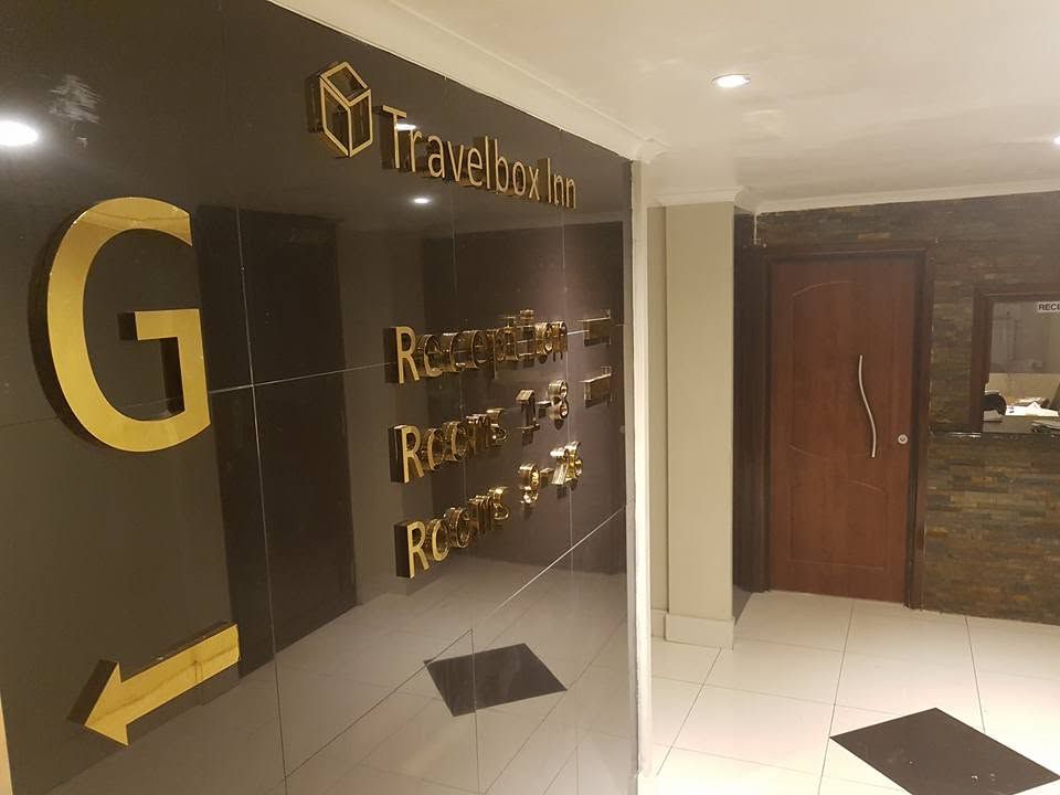Reception hallway featuring building directory and gold lettering on black marble.