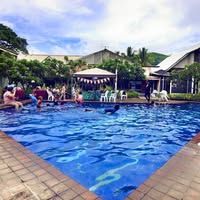 Outdoor swimming pool with guests enjoying the water and poolside seating.